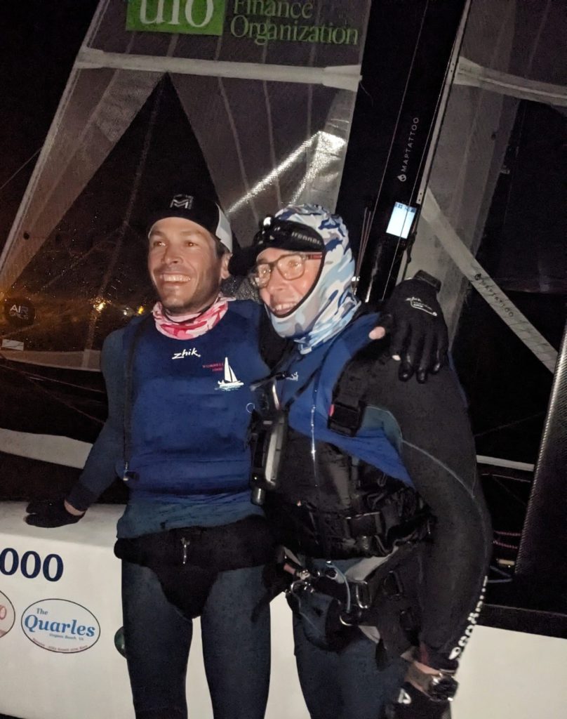 Matthieu, Manu, and their catamaran (peak MAPTATTOO on their mast)
